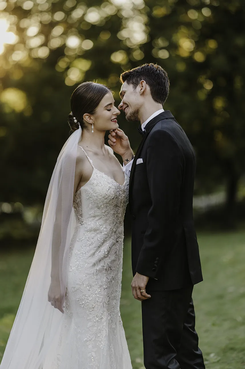 Para młoda uśmiecha się do siebie w promieniach zachodzącego słońca